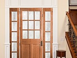 Woodgrain 9 Lite Sash and Panel Door 9 over raised 2 panels with complementary sidelights with Delta Frosted Glass 6562 and 1705